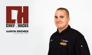 Chef Aaron in a black uniform with Chef Hacks logo in lettering