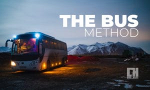 A large bus with mountains in the background